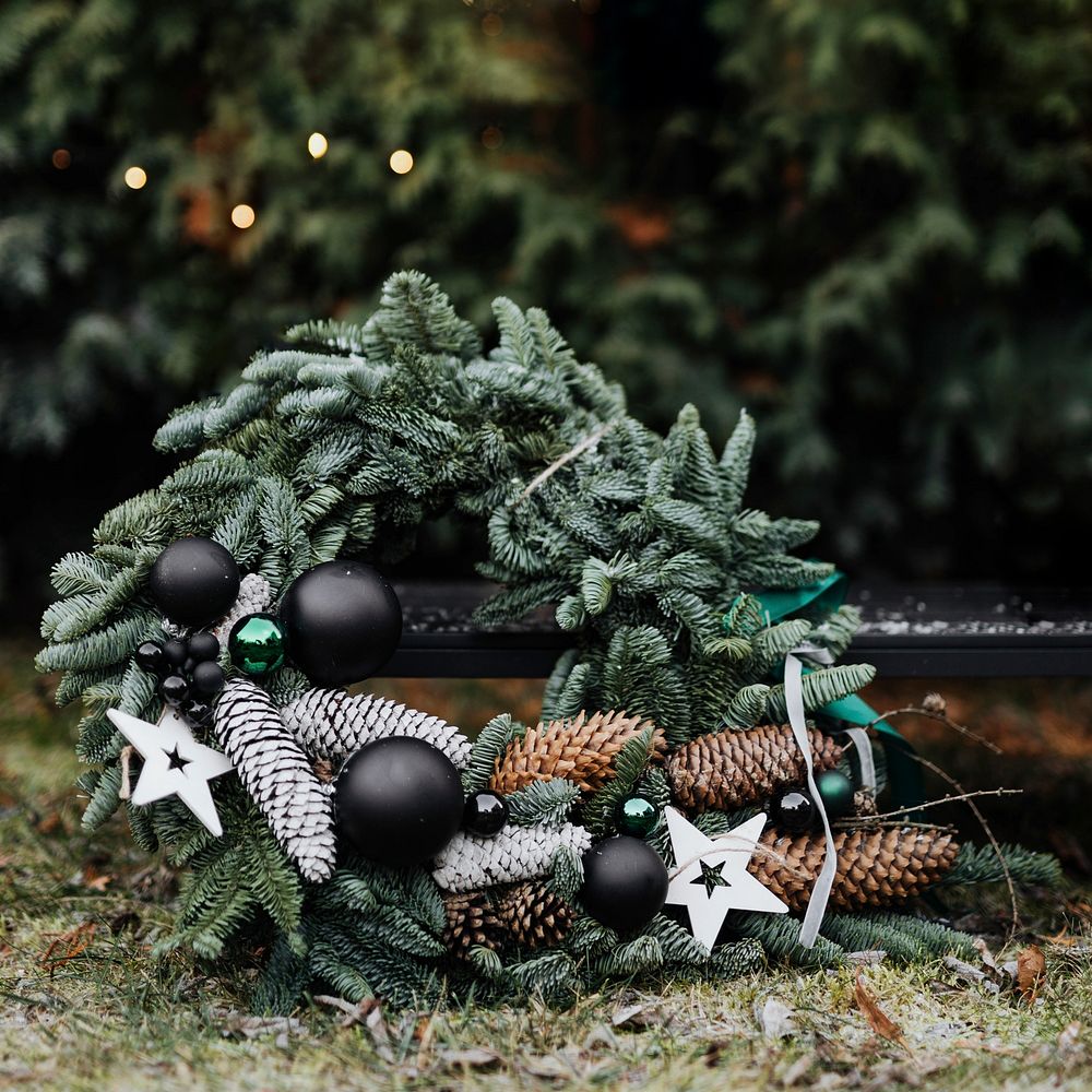 Green black white Christmas wreath in backyard