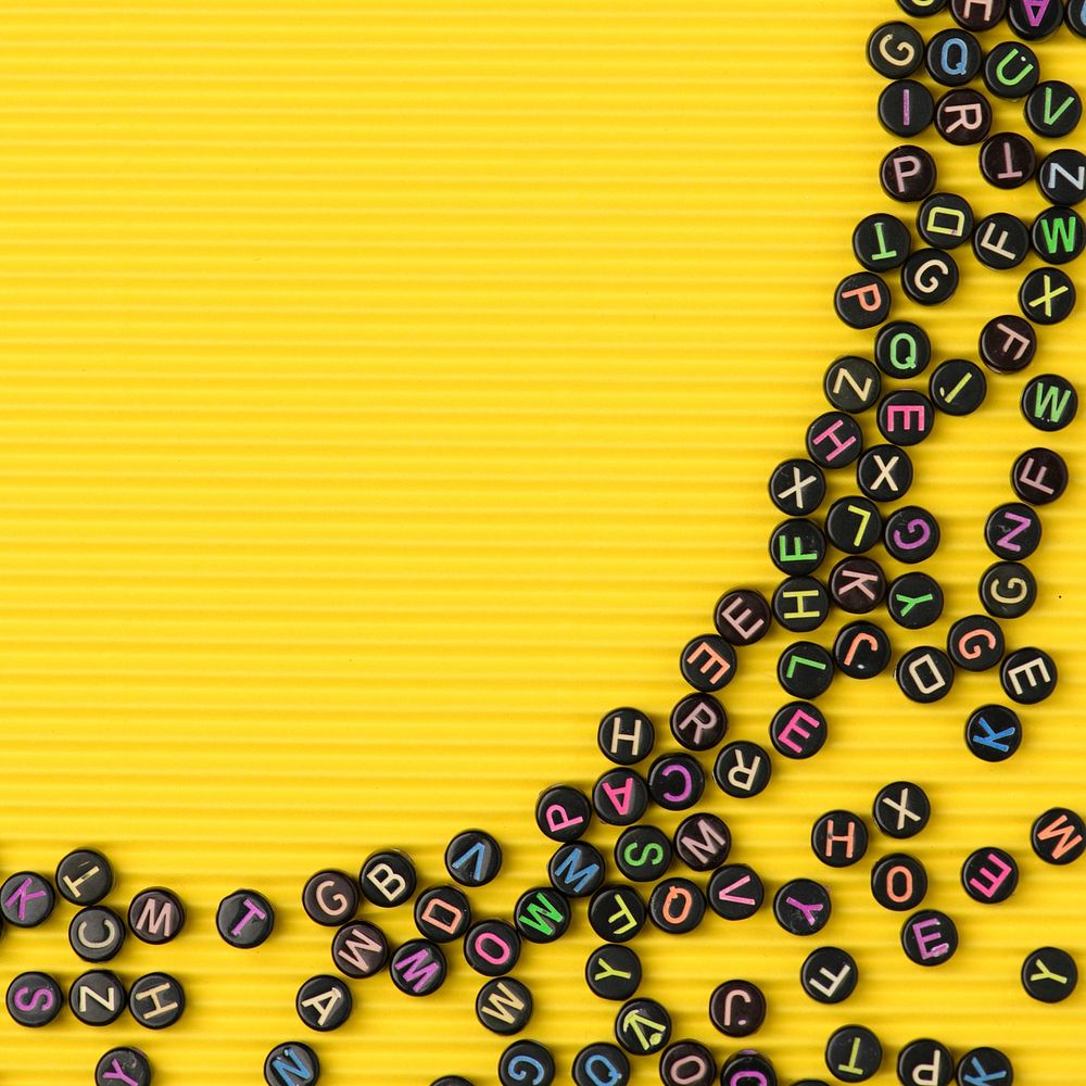 Black letter beads border yellow background