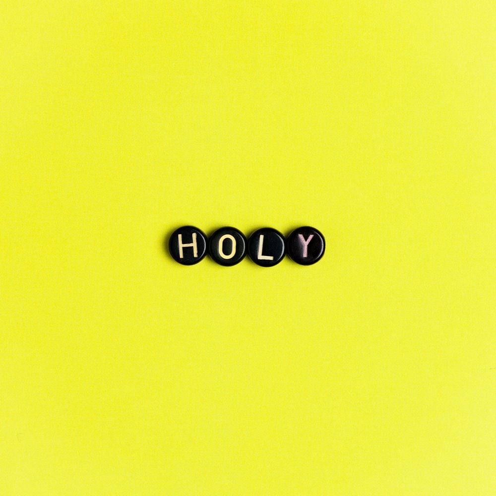 Holy text beads lettering typography on yellow 