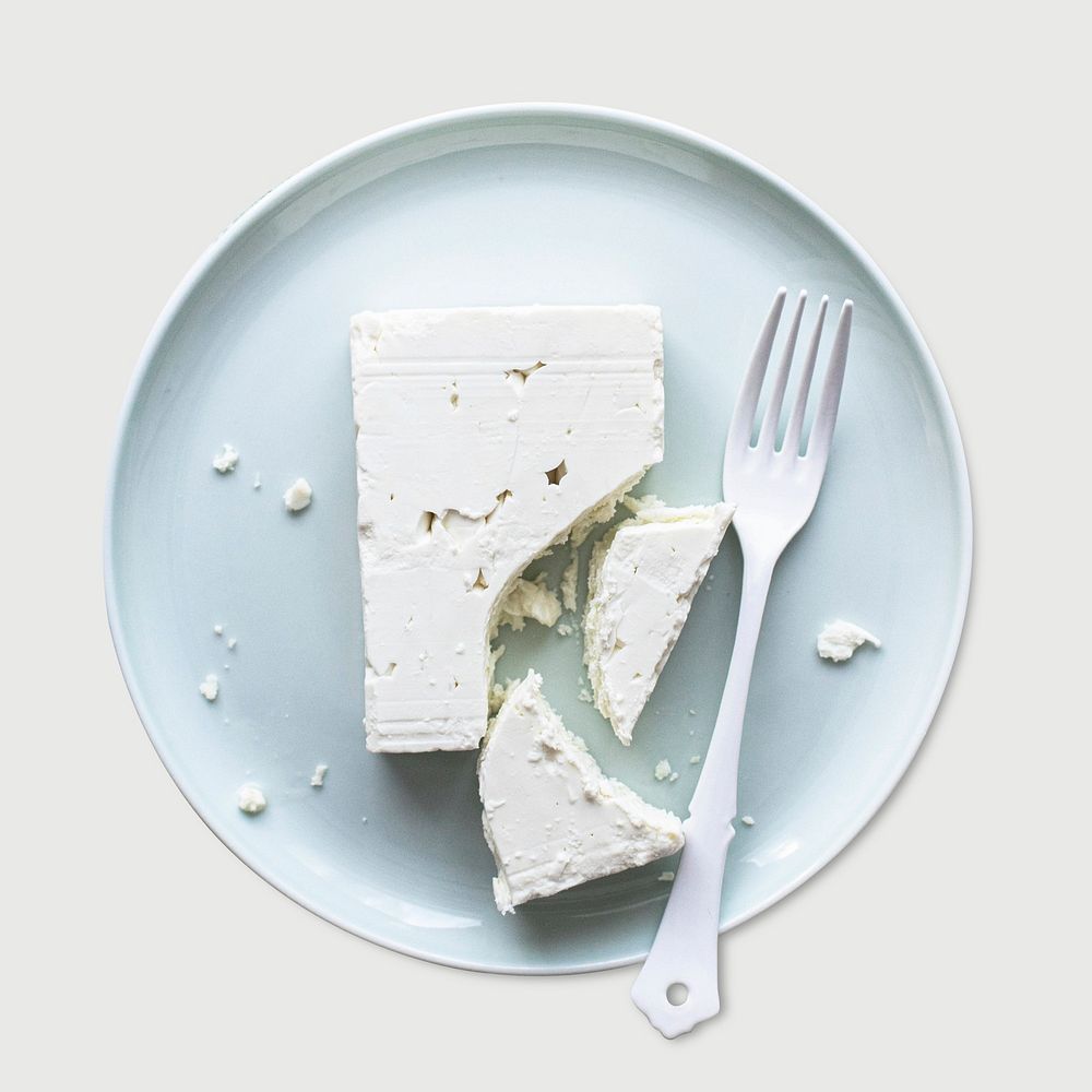 Psd feta cheese in white plate with fork