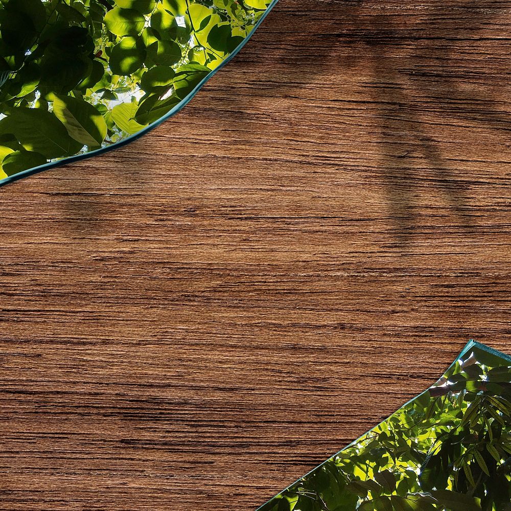 Wooden background PSD mockup with leaf patterned glass shard border frame  