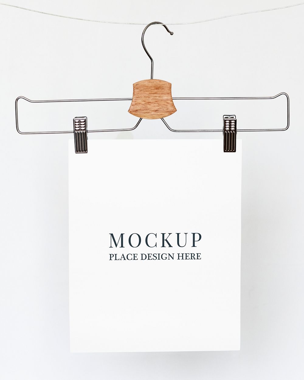 Papers mockup psd hanging from a cloth hanger 