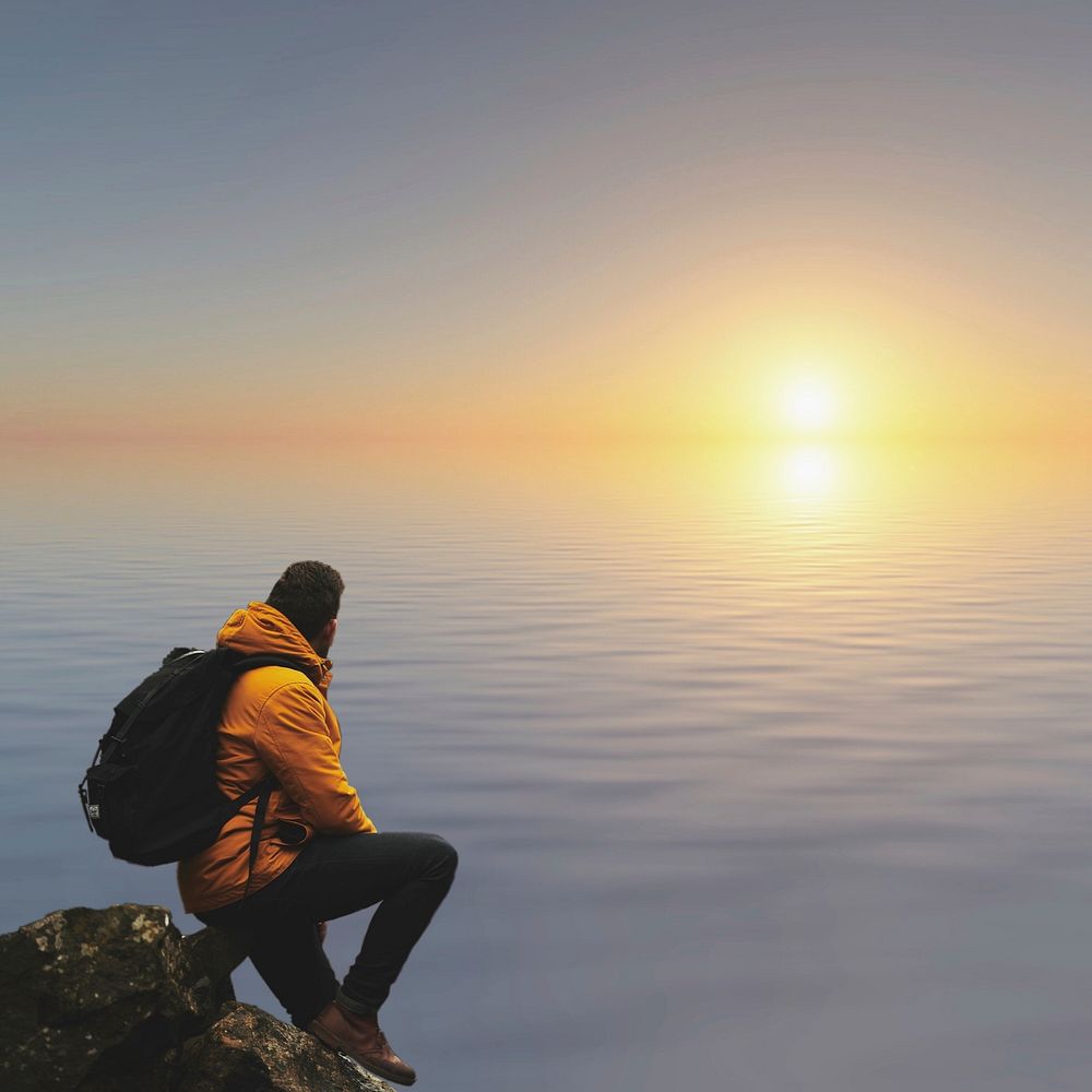 Man sitting on a cliff facing ocean view, free public domain CC0 photo.