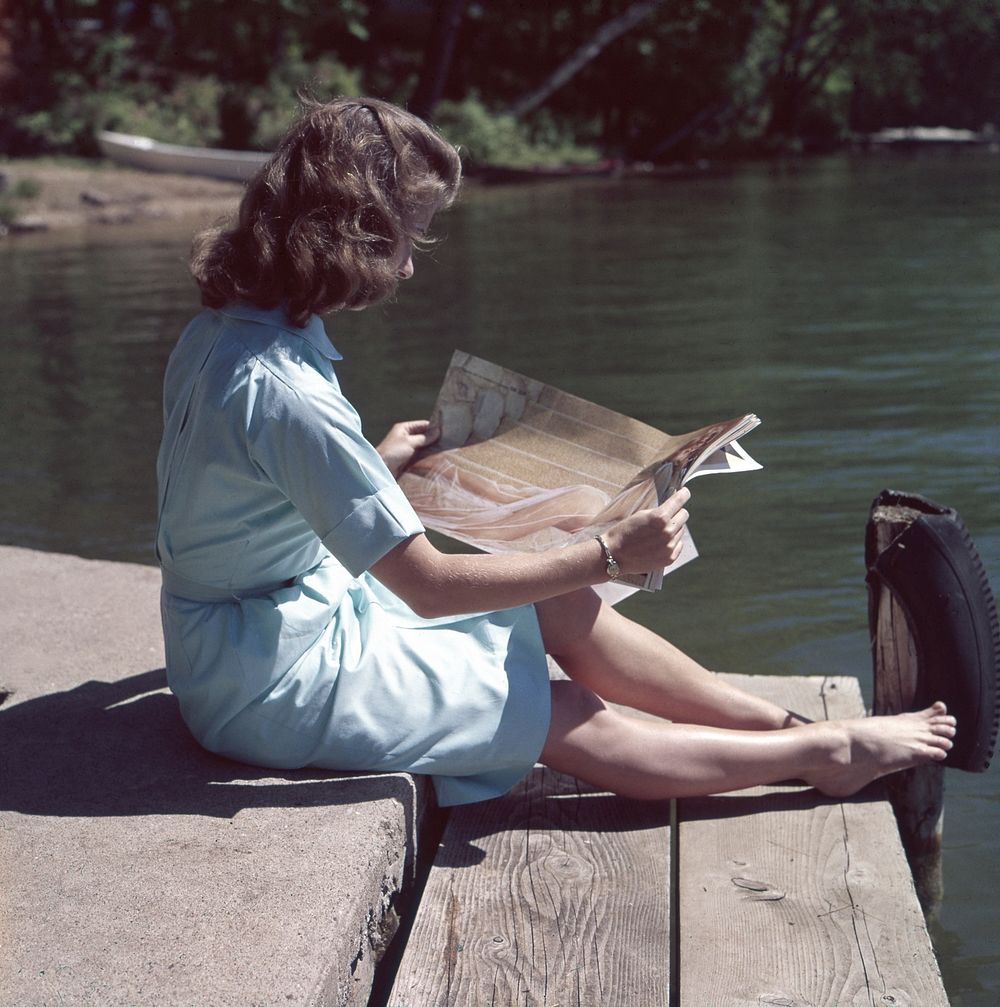 Free woman reading magazine near a river image, public domain CC0 photo.