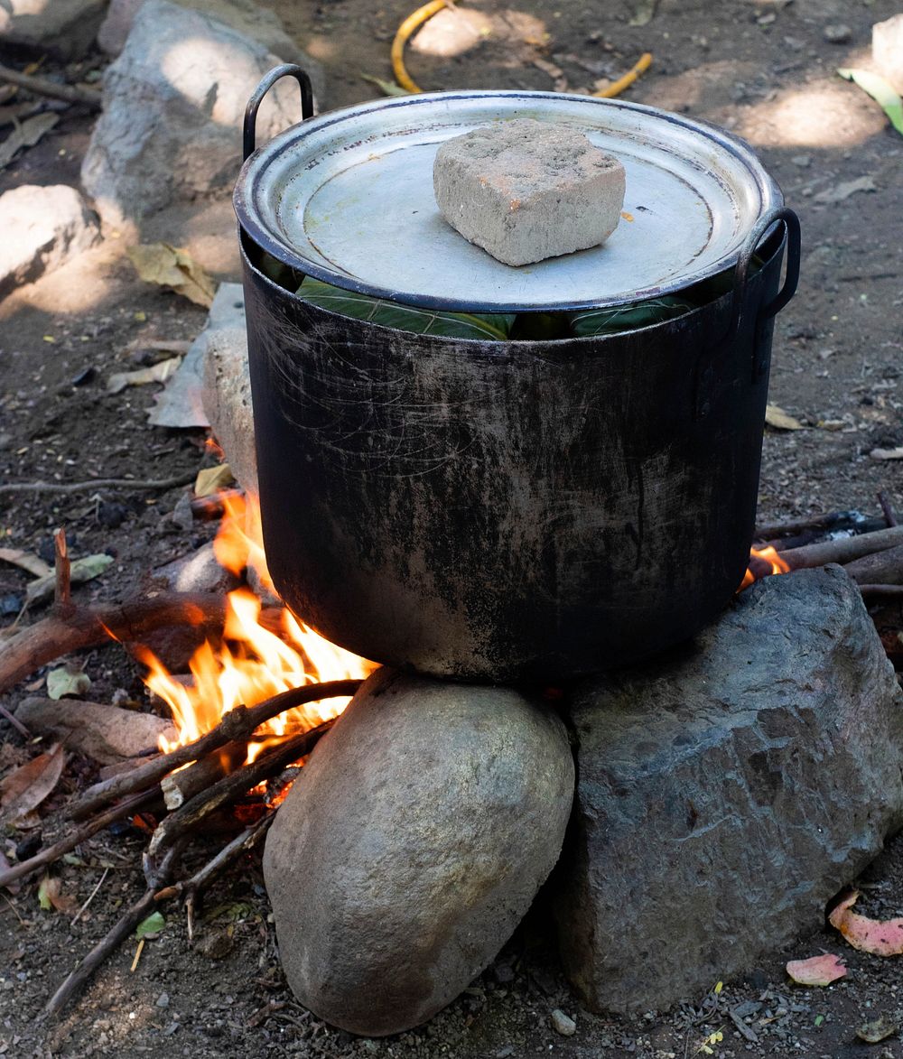 Free big cooking pot steaming over fire image, public domain CC0 photo.