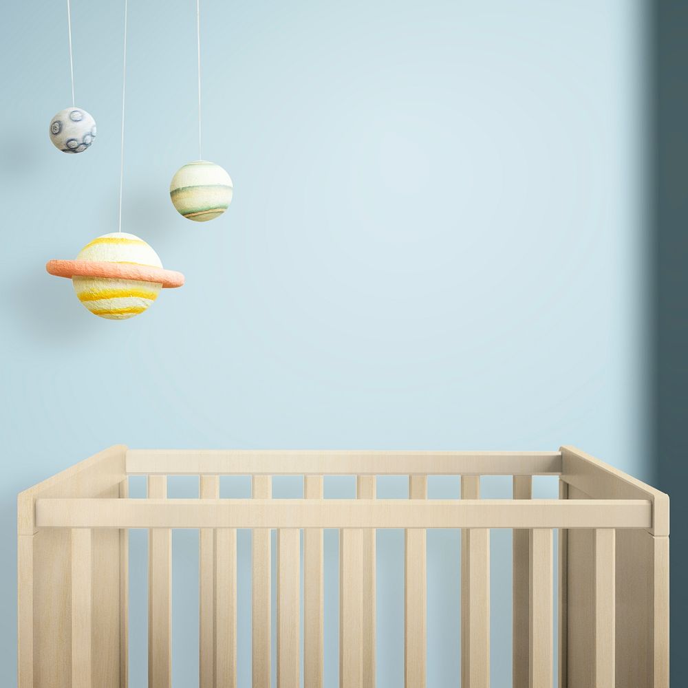 Wooden crib in a blue nursery room