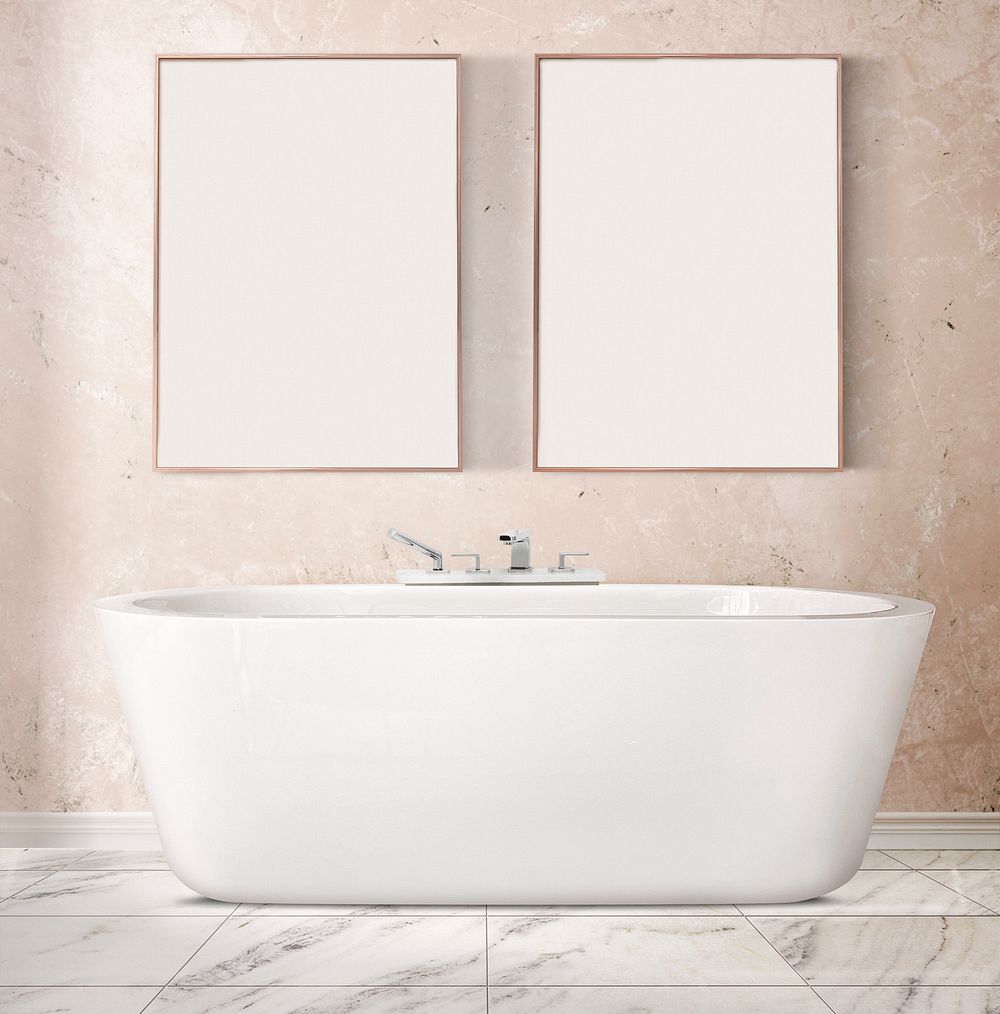 Blank picture frames hanging over a bathtub in luxury bathroom interior design