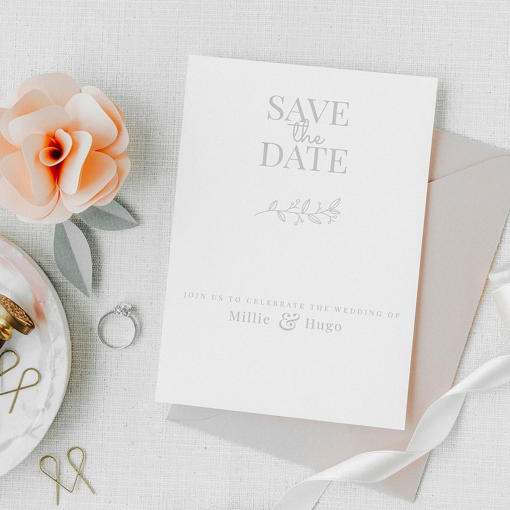 Aesthetic wedding invitation and ring on a table