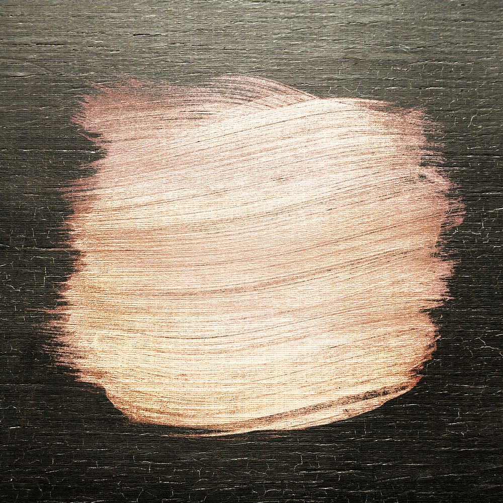 Rose gold oil paint brush stroke texture on a colored wood background
