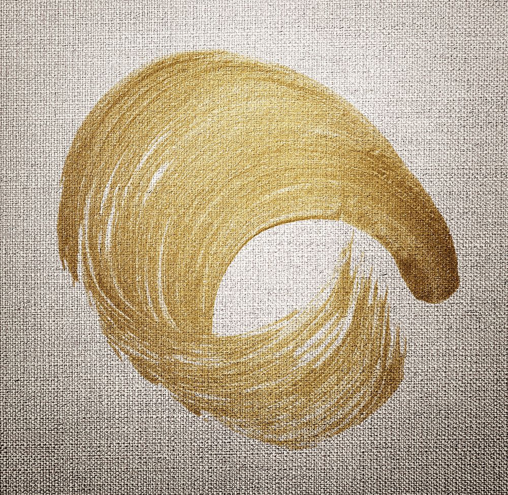 Gold oil paint brush stroke texture on a brown fabric textured background