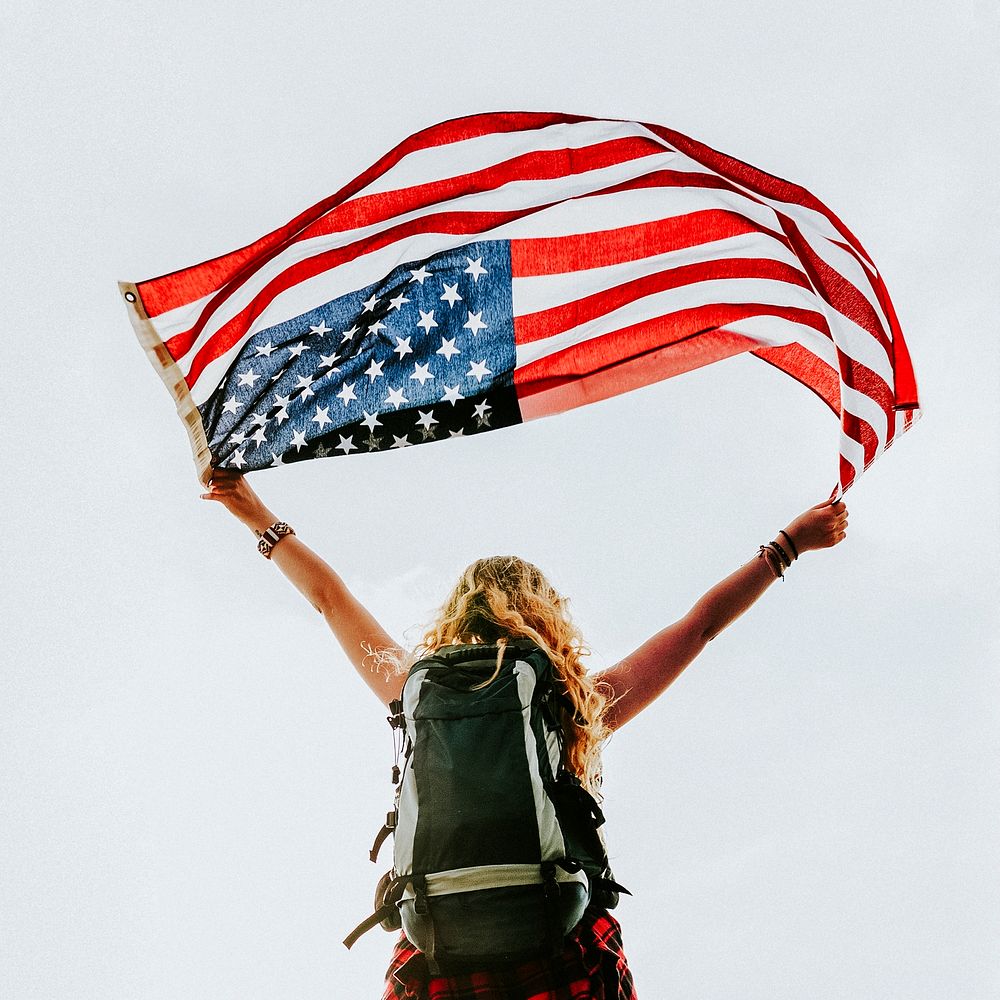 Caucasian woman holding American flag