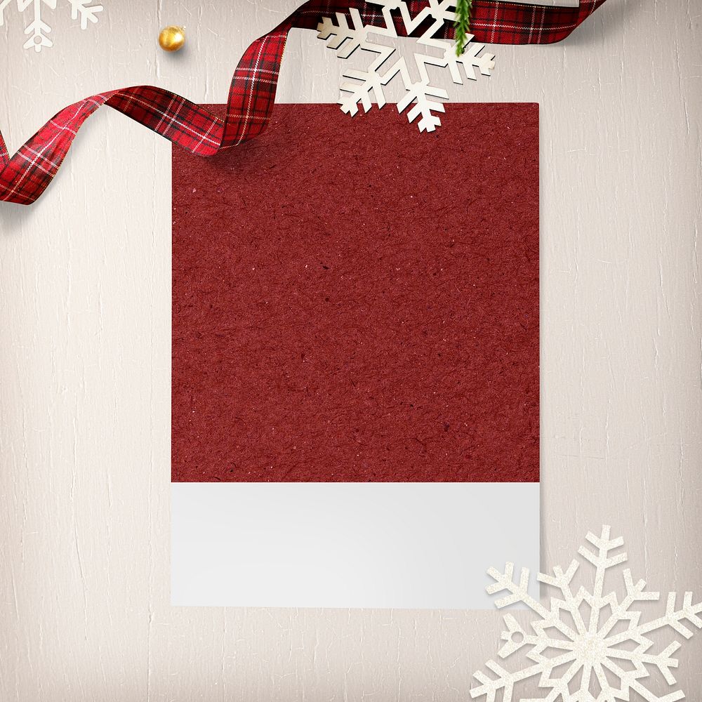 Blank photo frame mockup with Christmas decorations on cream background