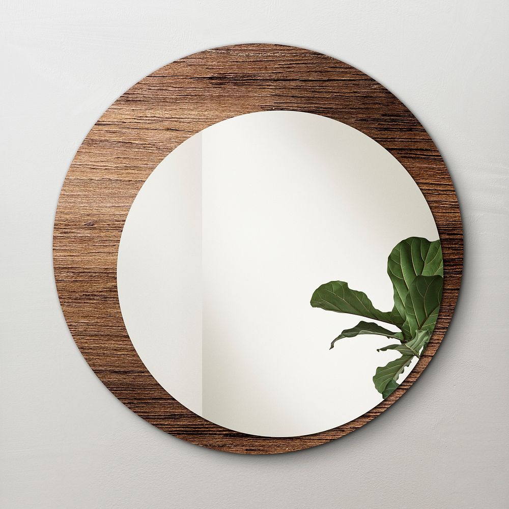 Circular mirror with a wooden backdrop with fiddle-leaf fig