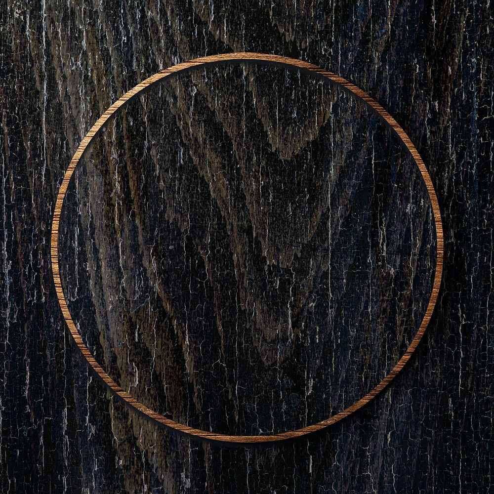 Round golden frame on black wooden texture background