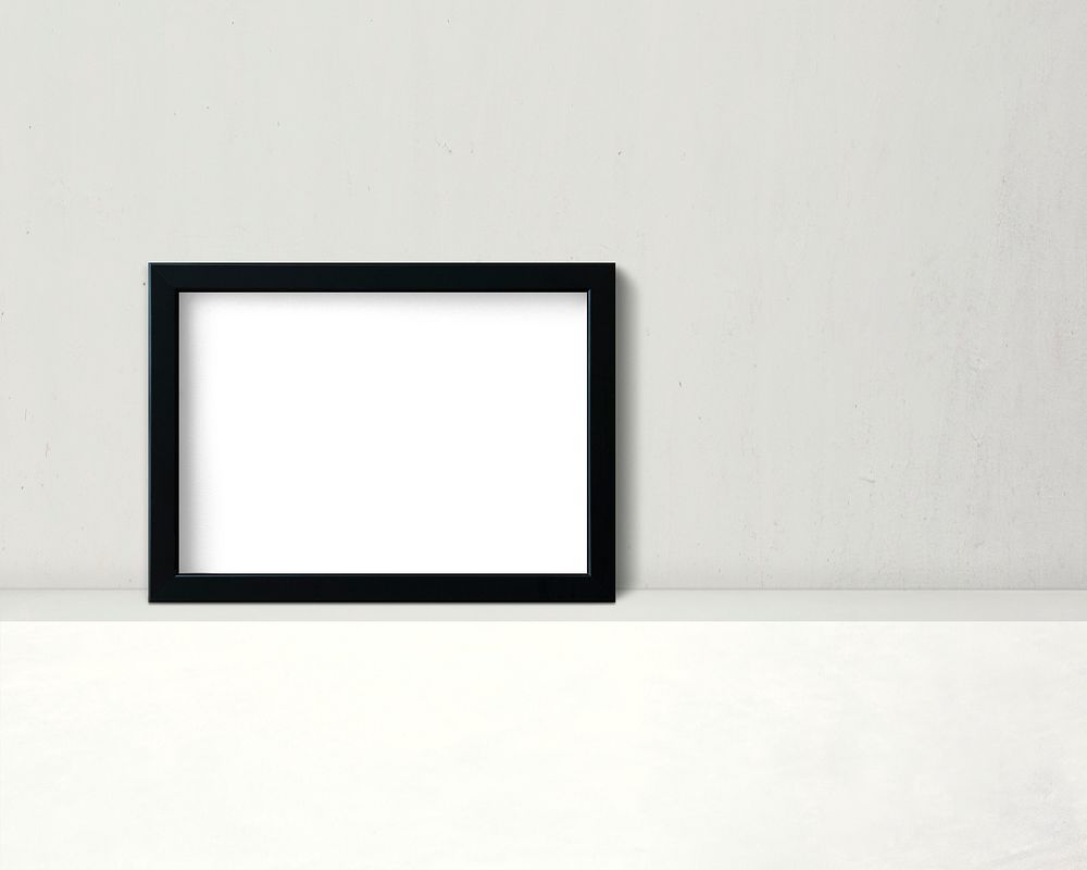 Black frame mockup against a wall