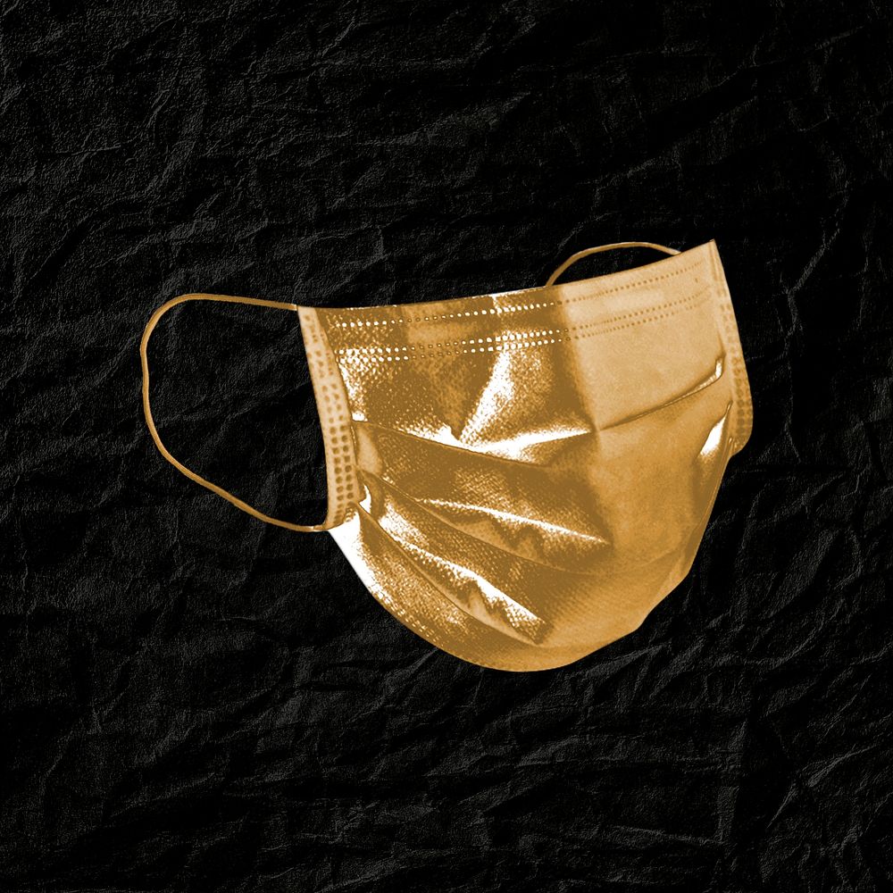 Golden face mask on a black leather textured background