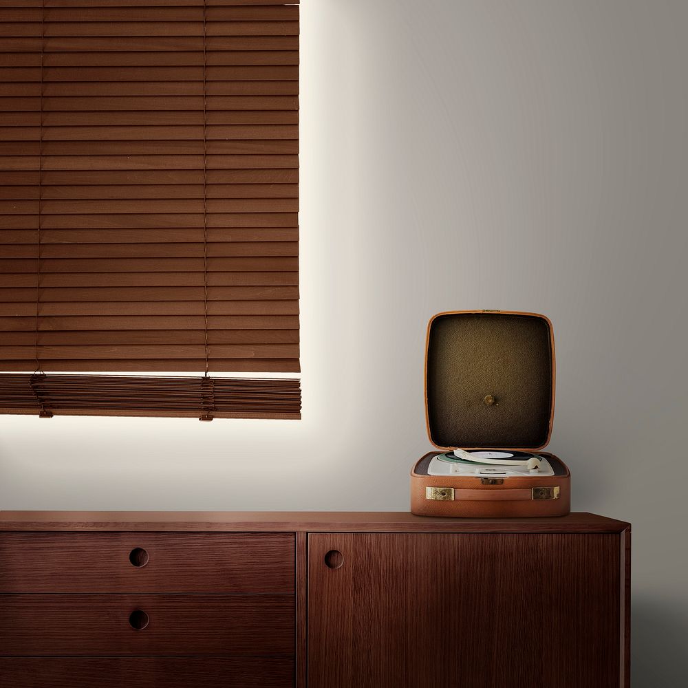 Vintage vinyl record player on wooden sideboard