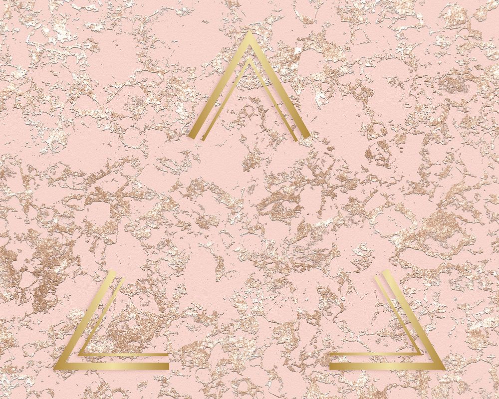 Gold triangle frame on a rough rose gold background
