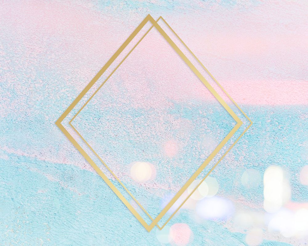 Gold rhombus frame on a pastel pink and blue concrete textured background