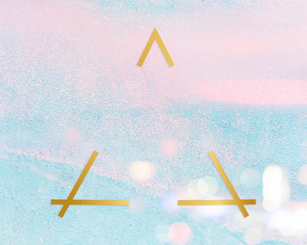 Gold triangle frame on a pastel pink and blue concrete textured background