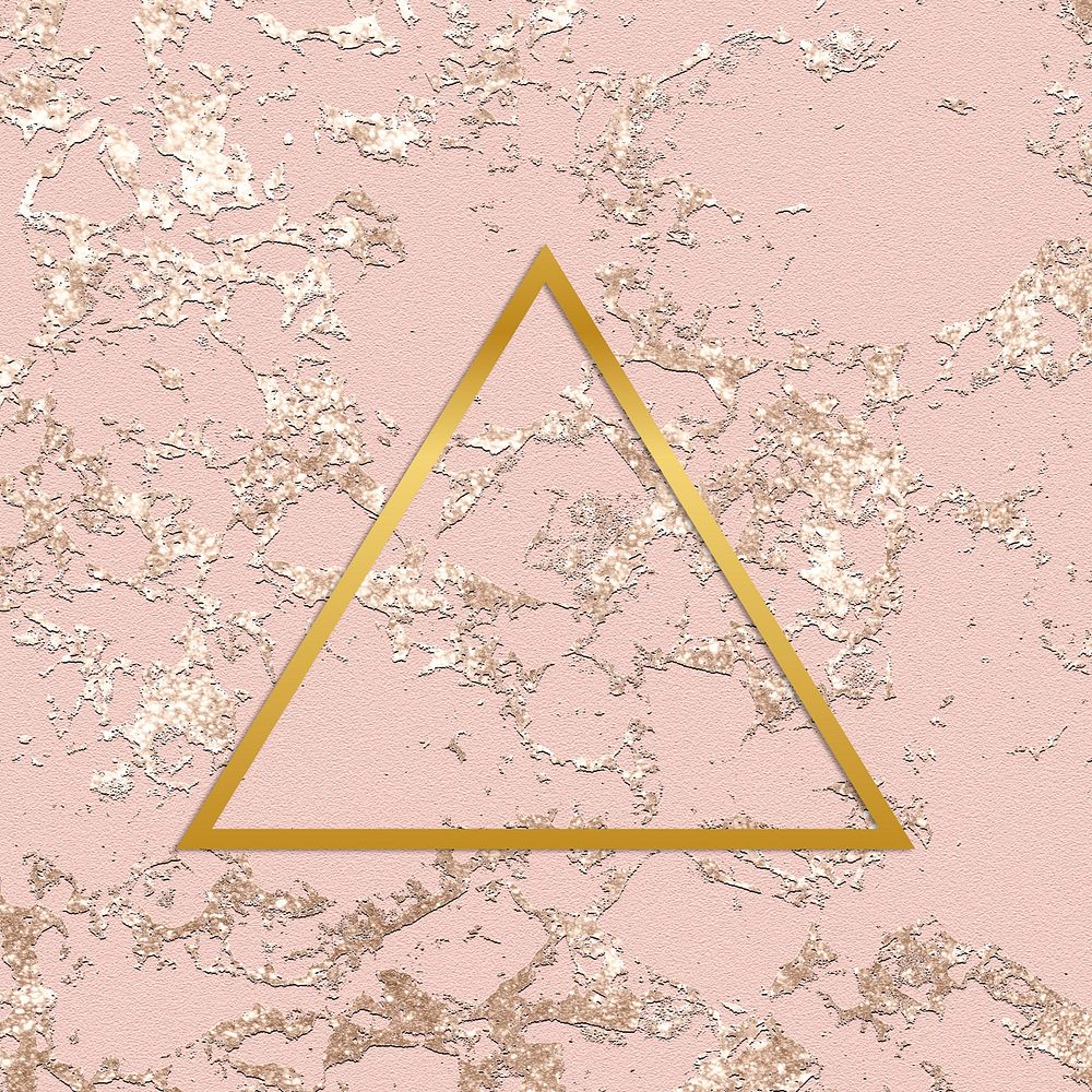 Gold triangle frame on a rough rose gold background