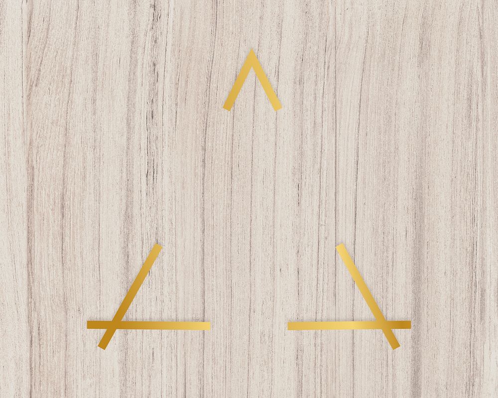 Gold triangle frame on a wooden background
