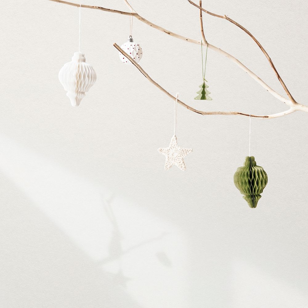 Christmas ornaments hanging on a tree on white background