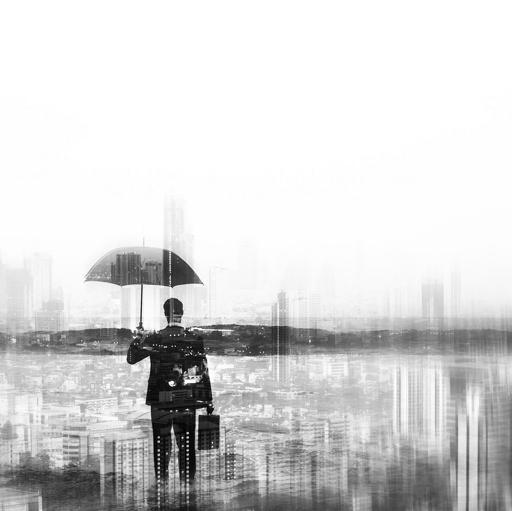 Businessman in suit holding umbrella on city background monochrome