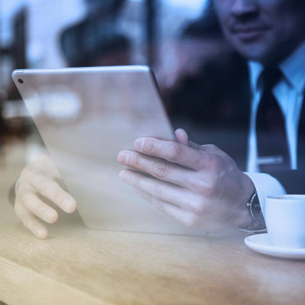 Businessman in cafe using tablet