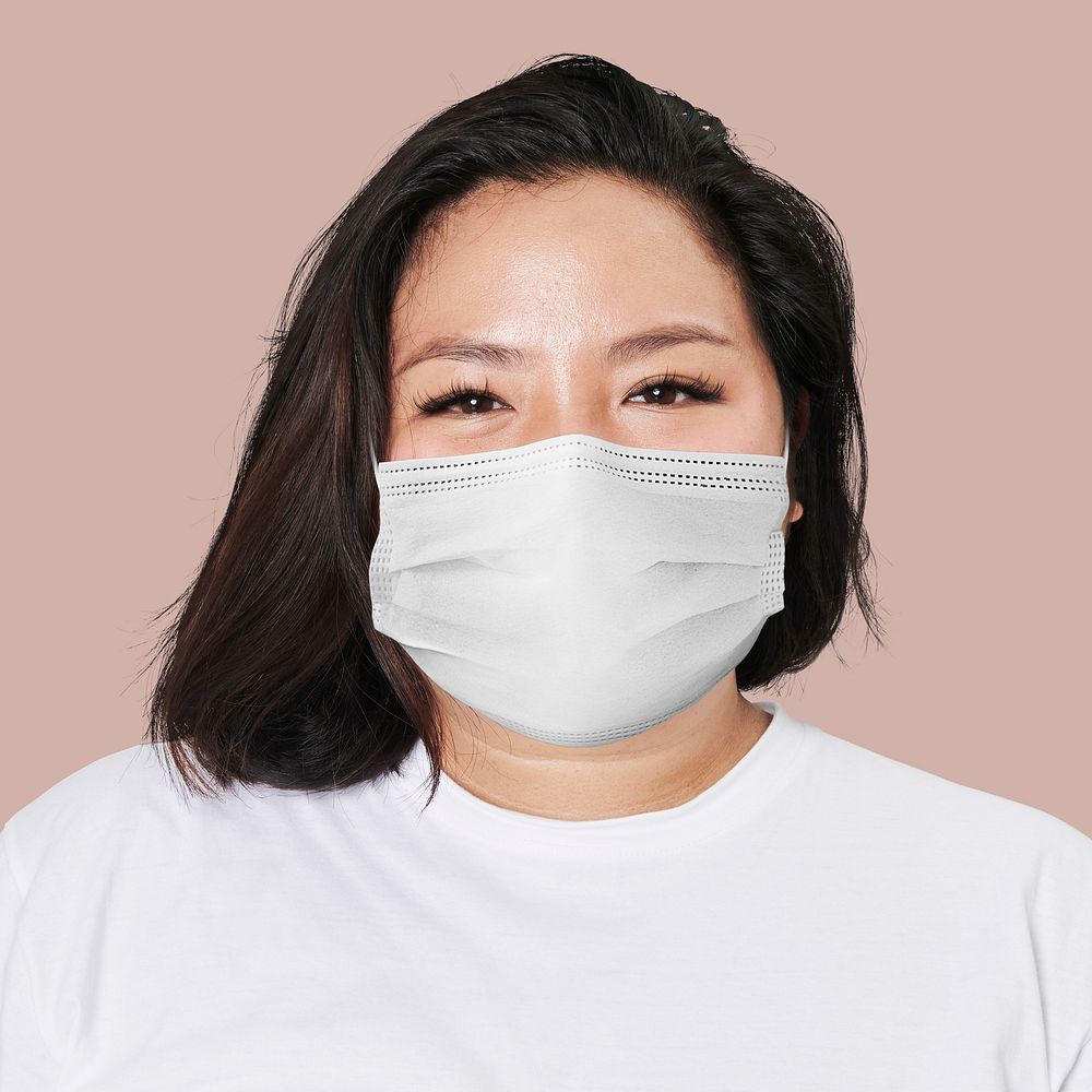 Woman wearing mask face closeup Covid-19 photoshoot on pink background