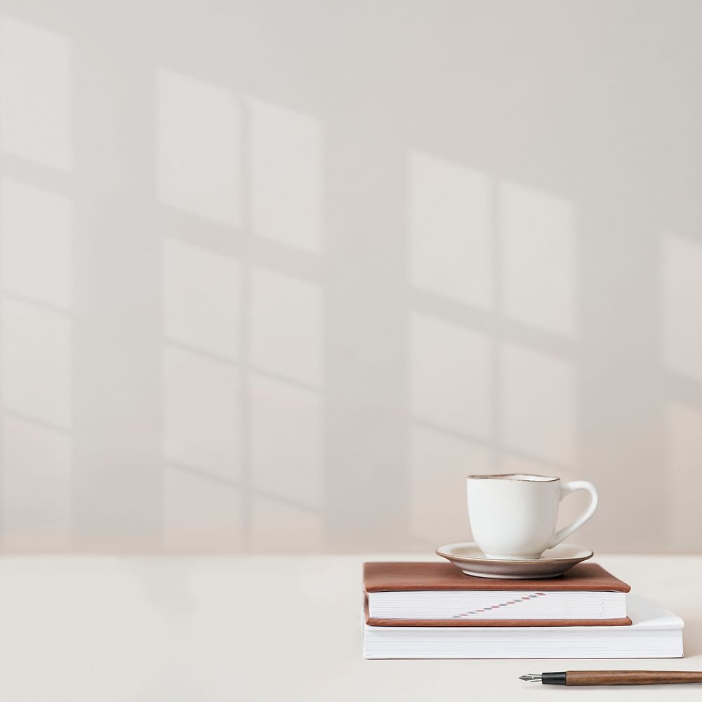 Wall background psd with coffee cup on top of books