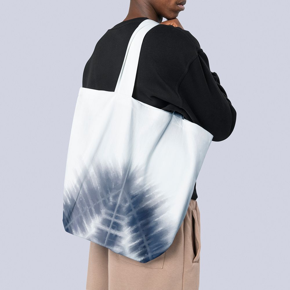 Man carrying a tote bag in Shibori tie dye pattern