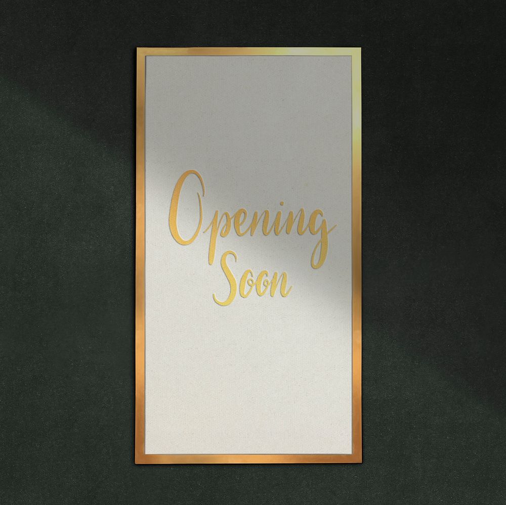 Golden frame on green wall with opening soon text