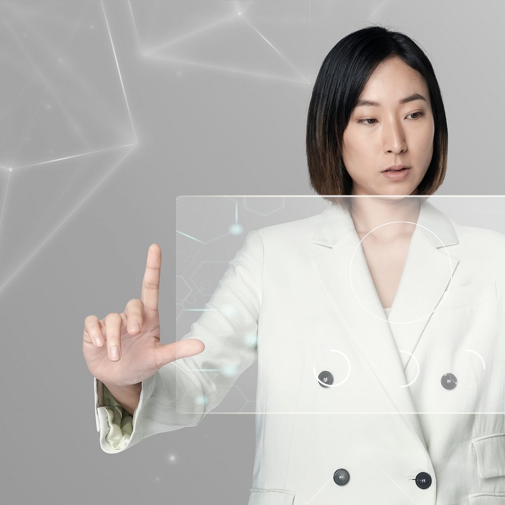 Asian woman using a futuristic transparent screen digital remix
