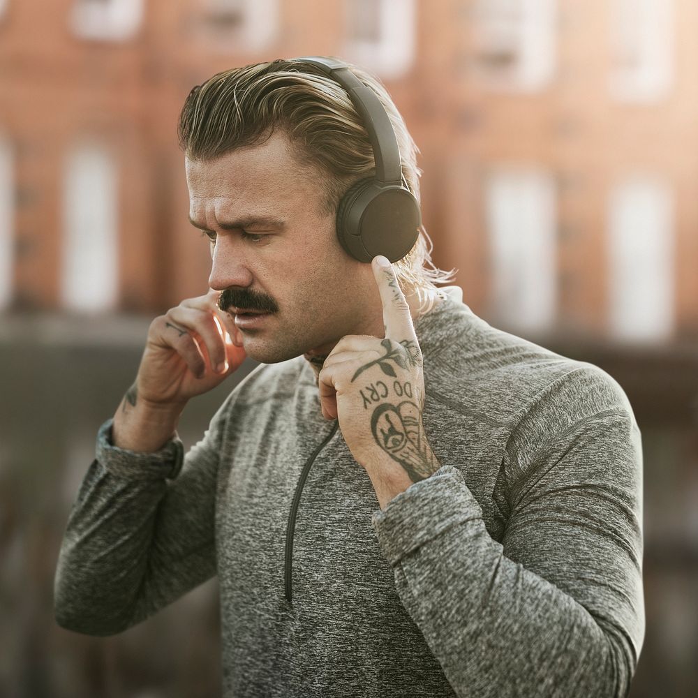 Man wearing wireless headphones psd remixed media