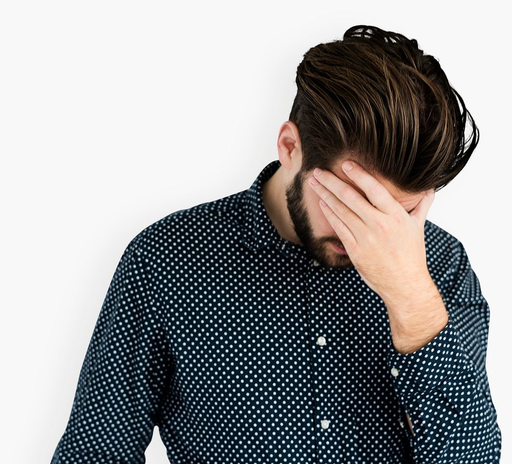 Depressed man covered forehead with his hand