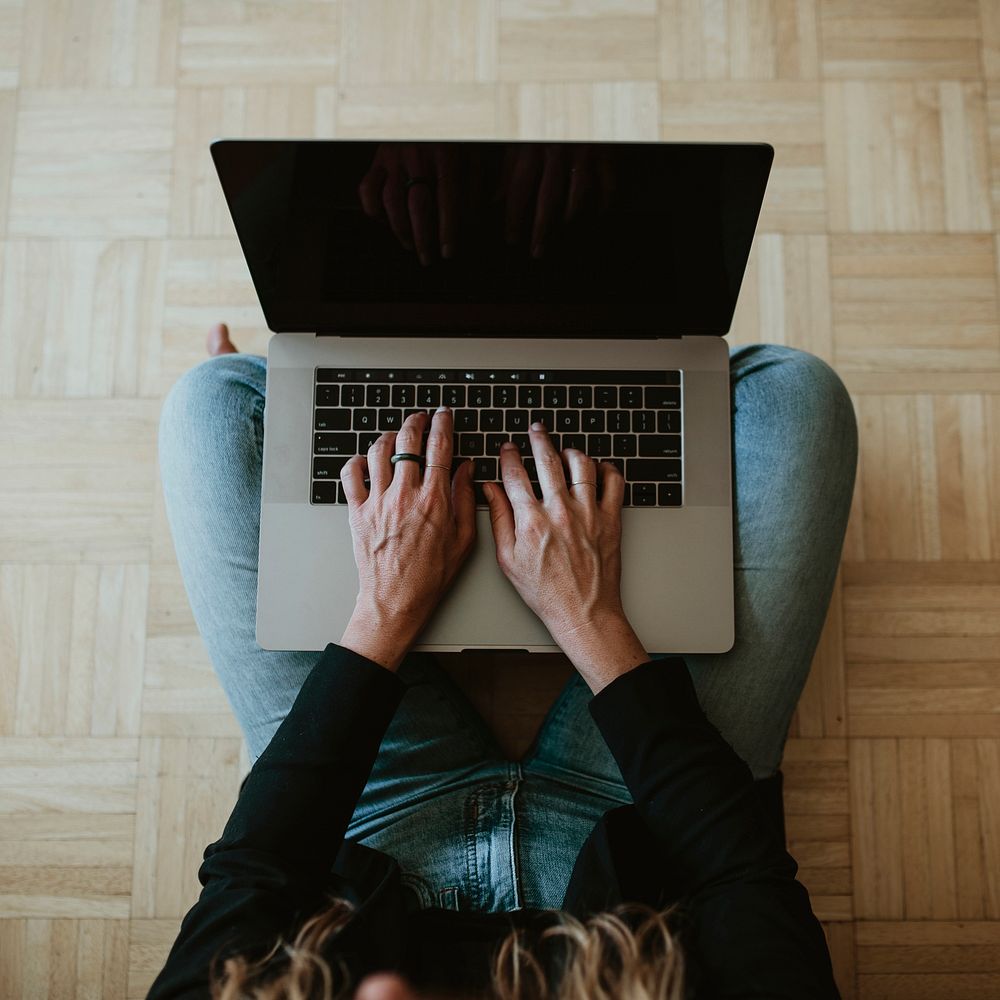 Woman using a laptop while working at home during the coronavirus outbreak 