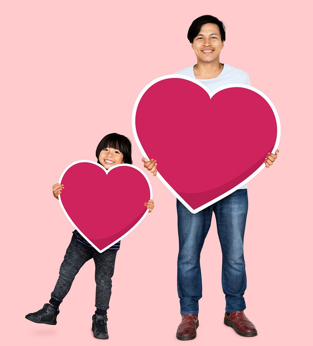 Happy father and son holding hearts