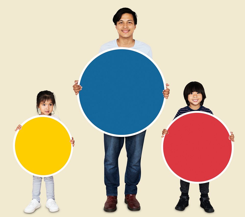 Happy family holding colorful round boards