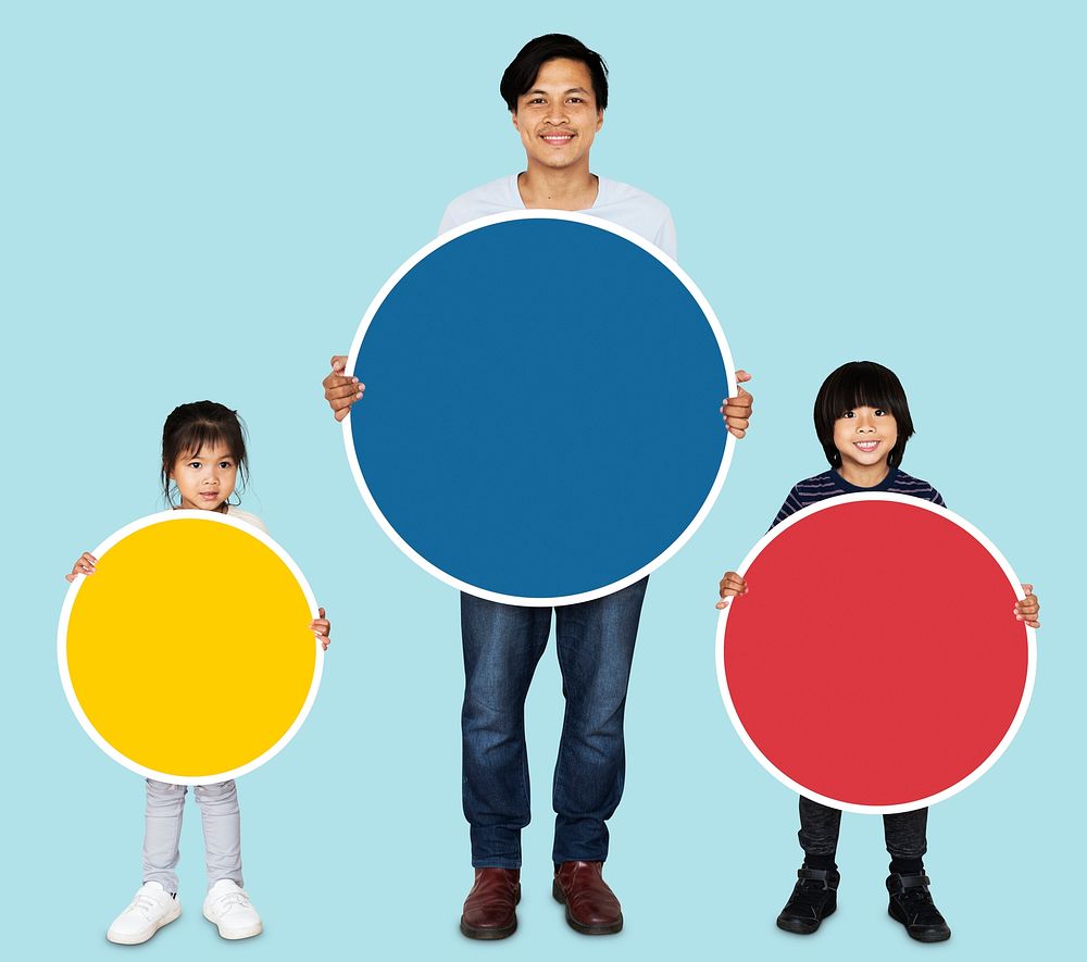 Happy family holding colorful round boards
