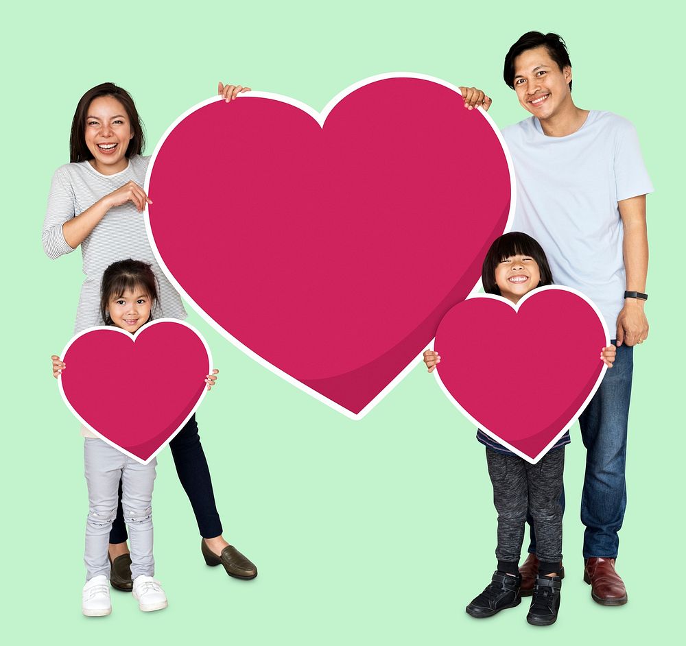 Happy family holding heart icons