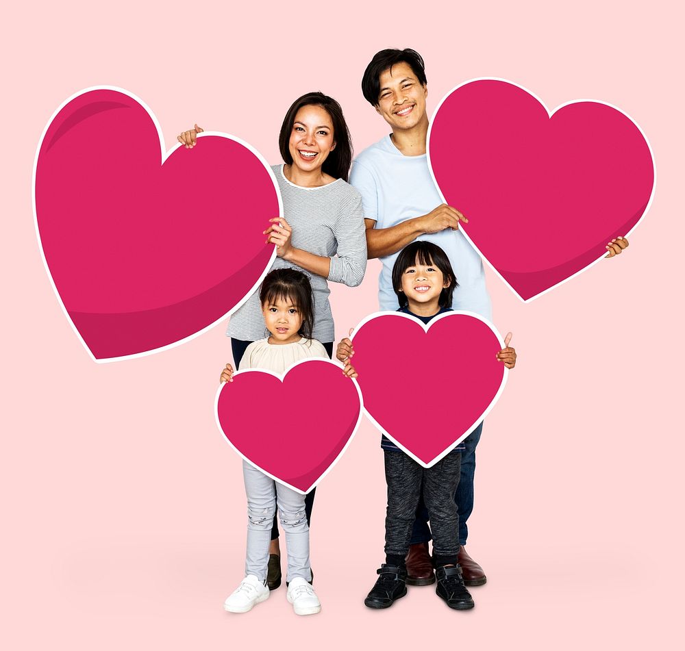 Happy family holding heart shapes