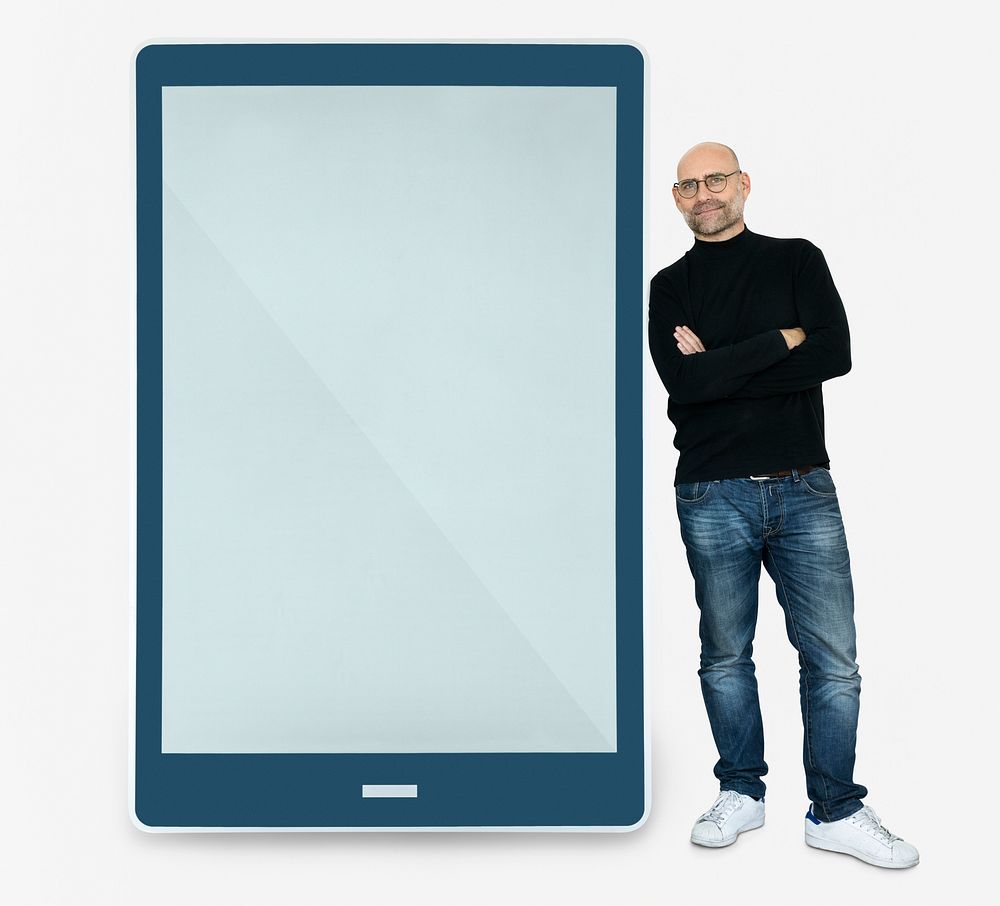 Happy man standing beside a tablet