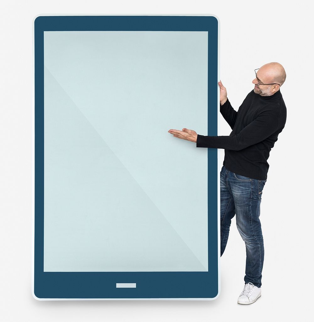 Cheerful man standing beside a tablet