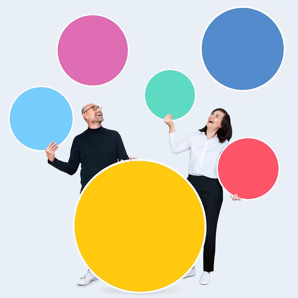 Happy people holding colorful round boards