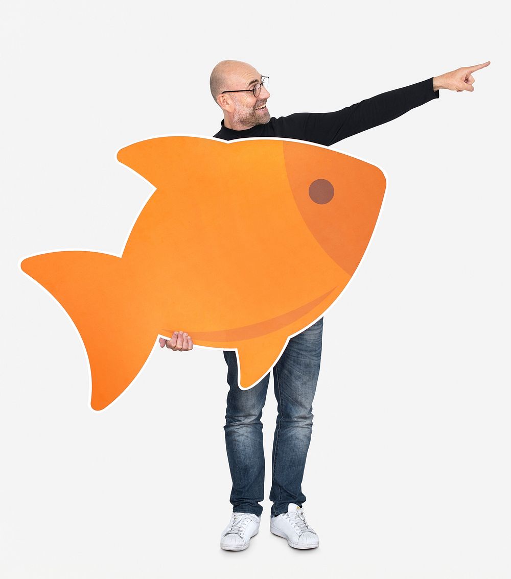 Happy man holding an orange fish