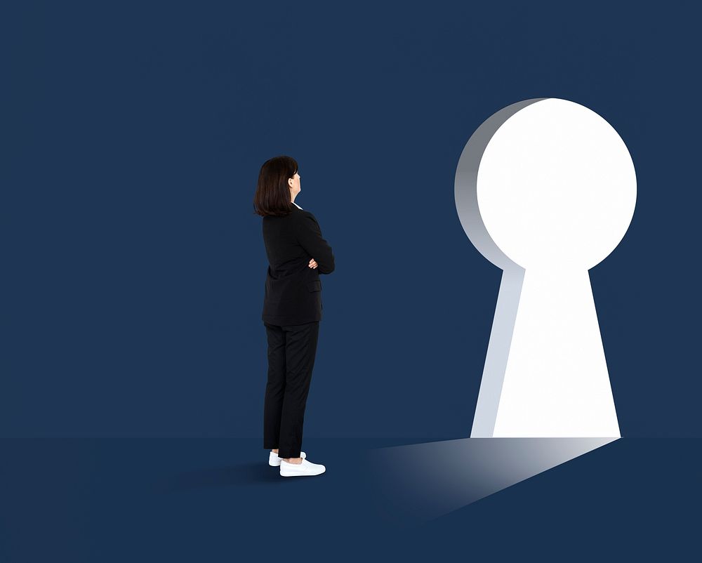 Woman standing in front of a huge keyhole