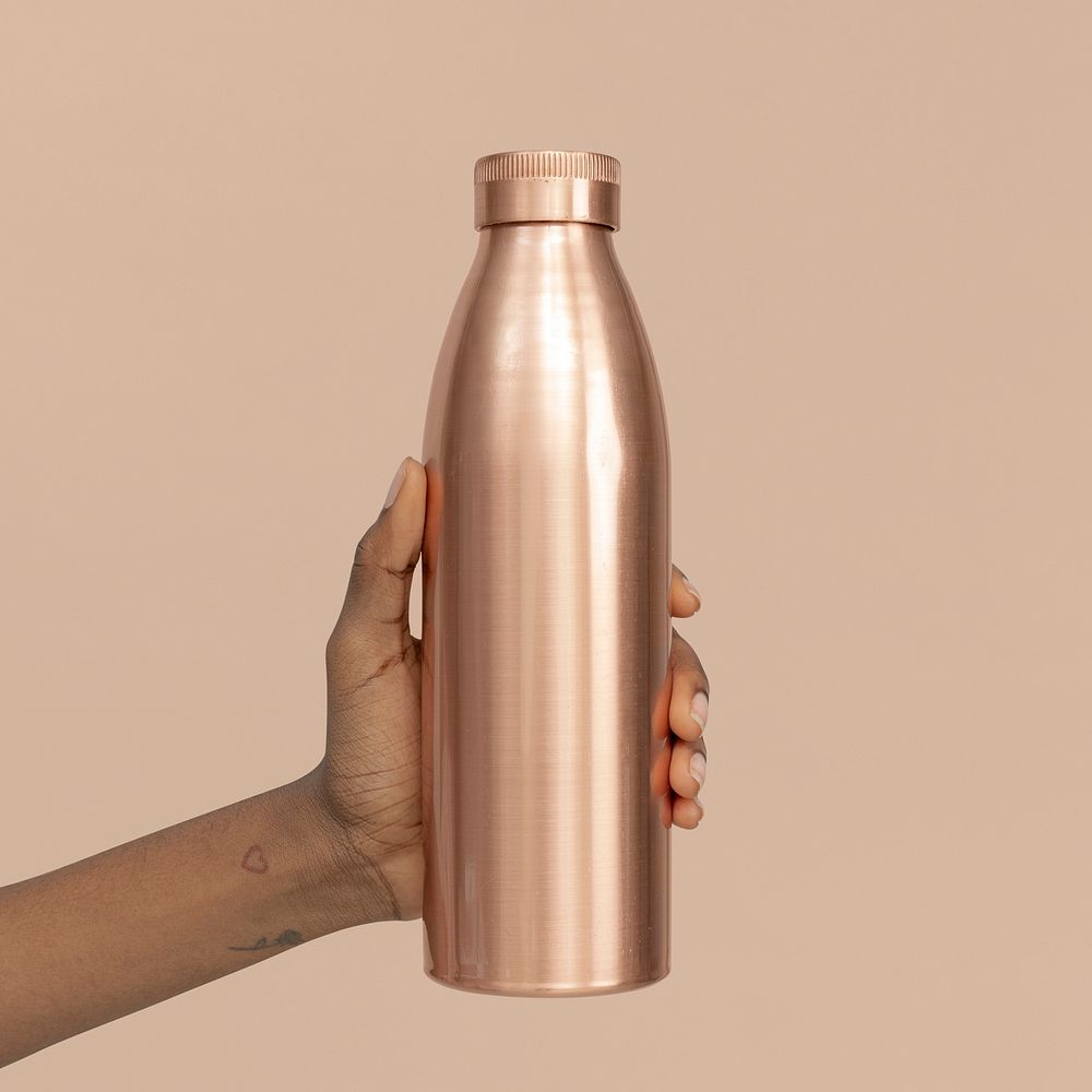Hand holding a copper stainless steel bottle mockup