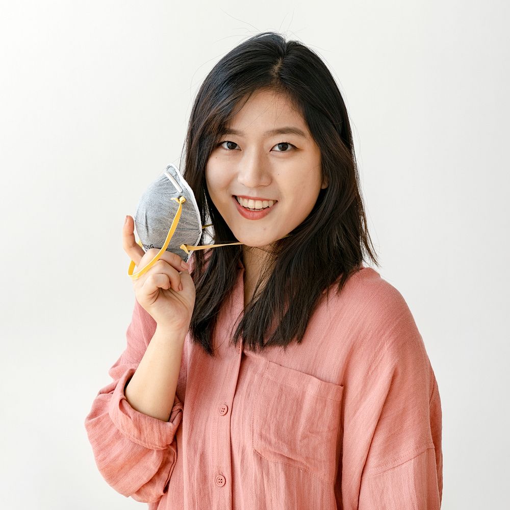 Smiling Asian woman with a face mask