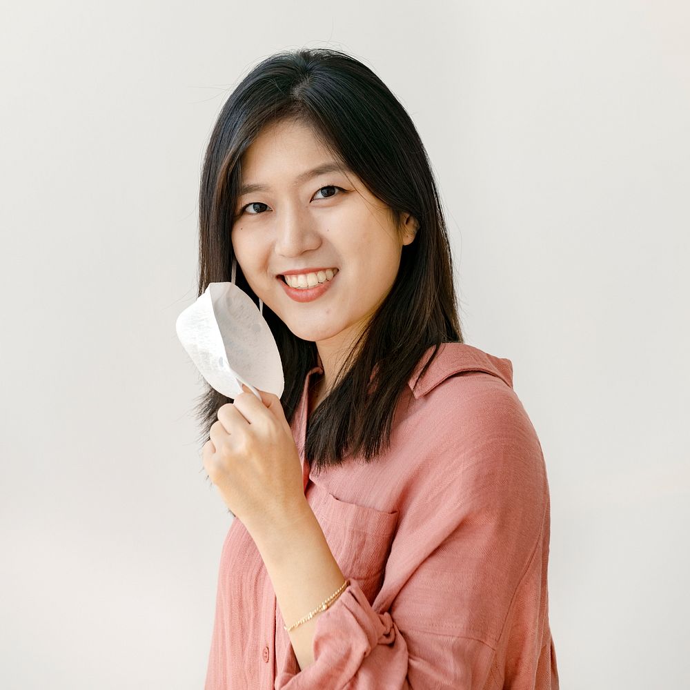 Smiling Asian woman with a face mask